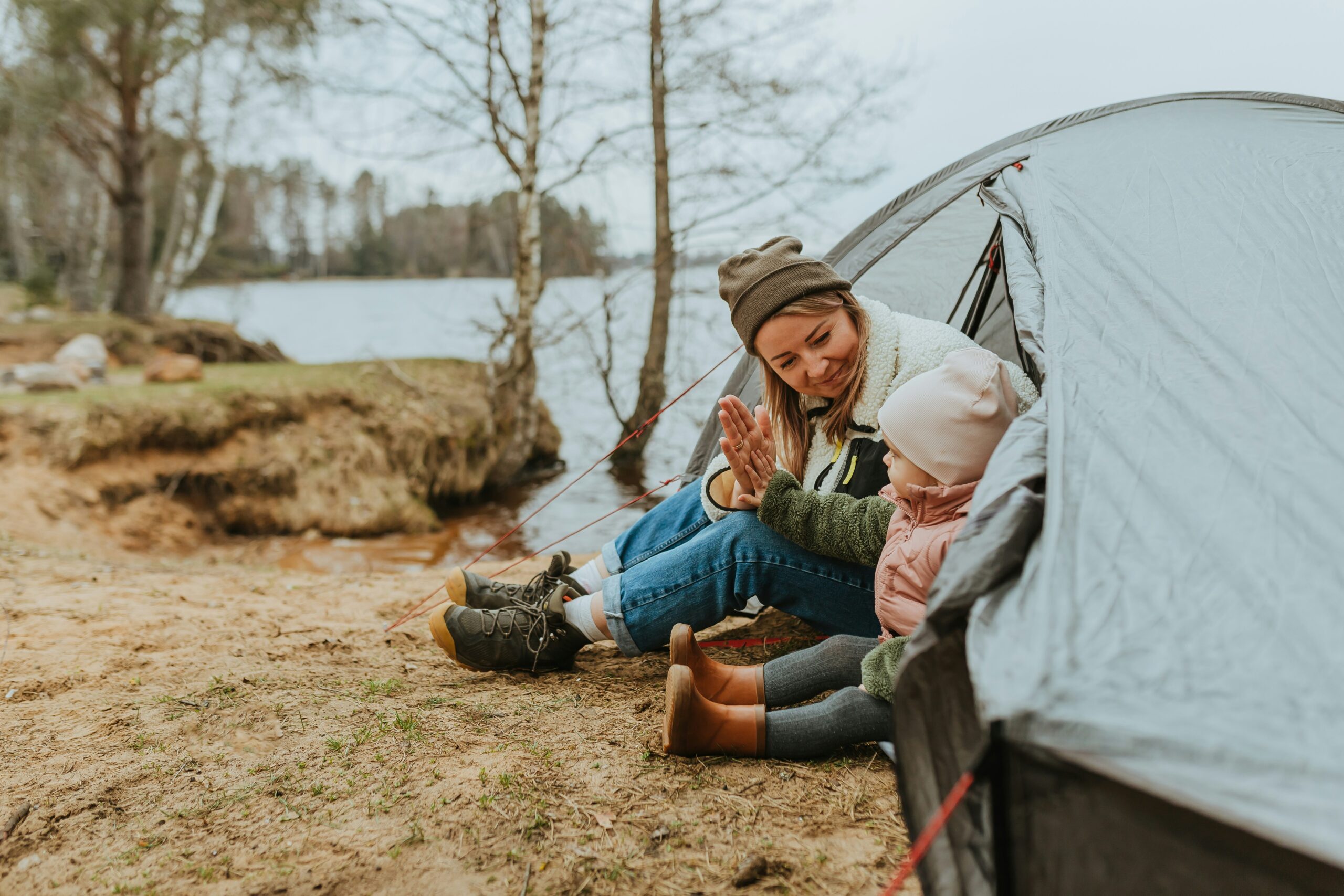 Kid-friendly camping, children playing happily in front of a tent