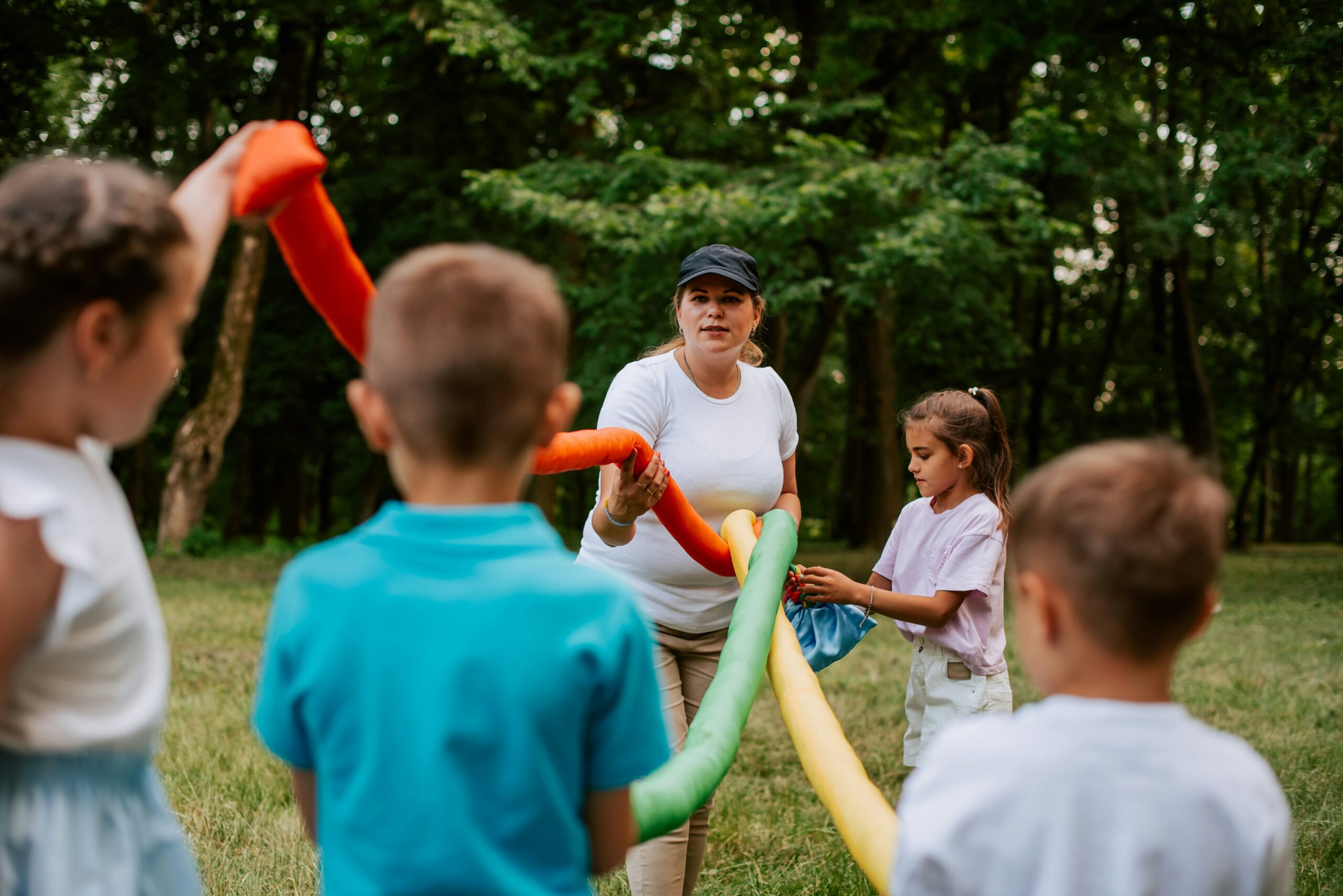 Group games for kids, children running happily on the outdoor grass