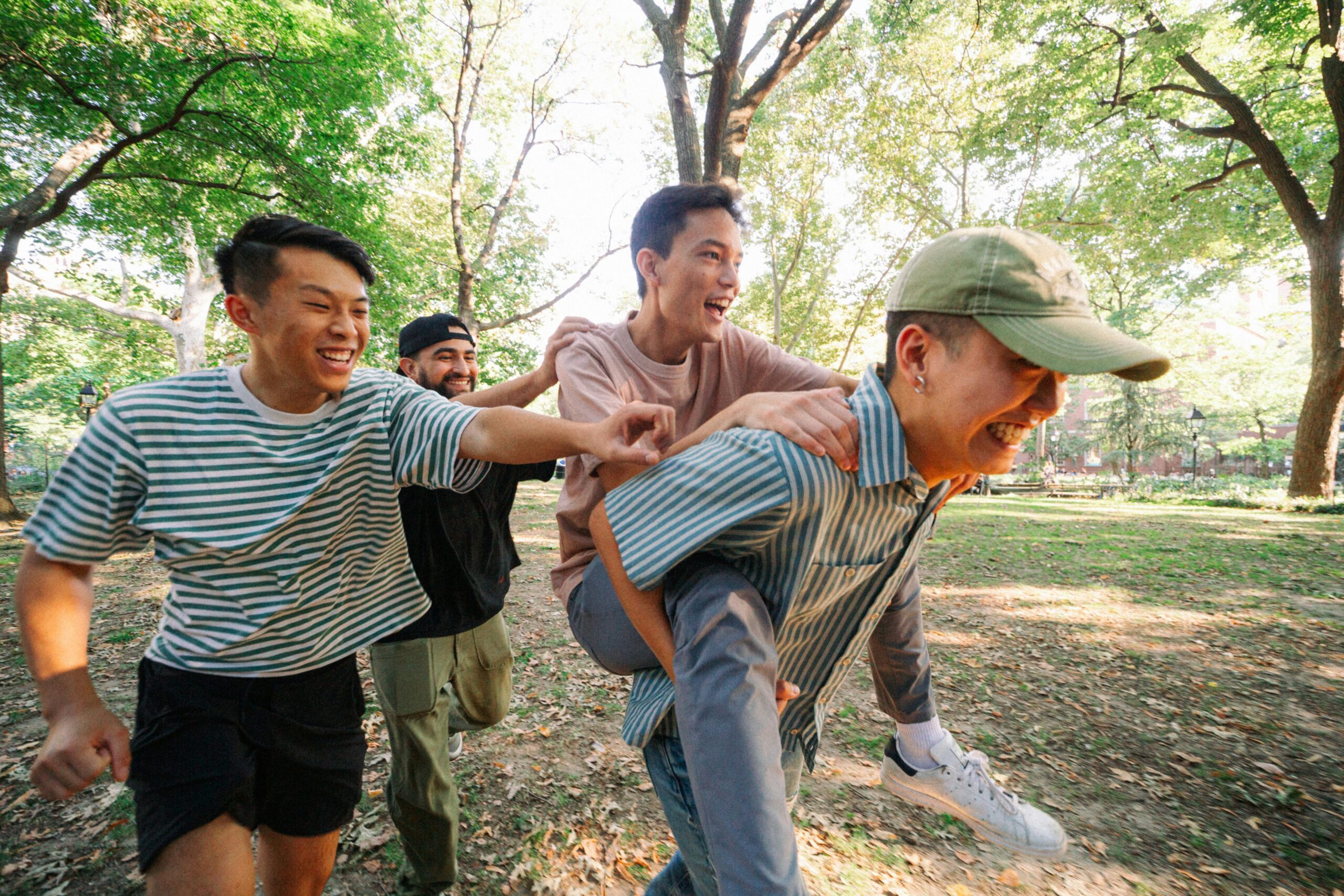 Team playing icebreaker games on the outdoor grass, full of laughter